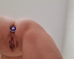 Baby with anal plug caresses shaved tight pussy