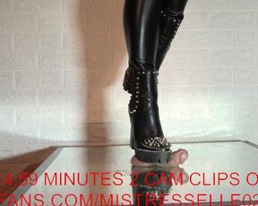 Mistress elle presents her spiked boots to her slave